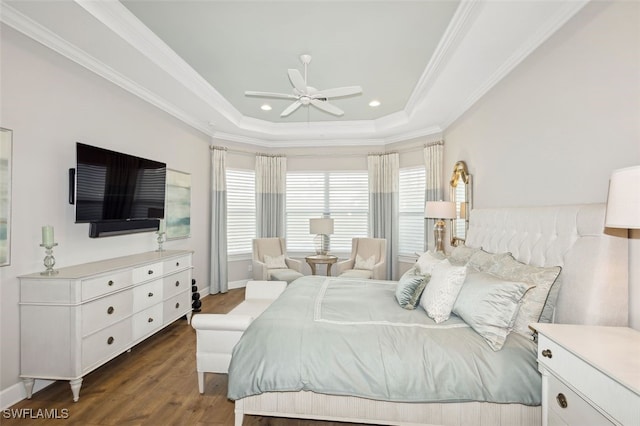 bedroom with dark hardwood / wood-style flooring, a tray ceiling, ceiling fan, and ornamental molding