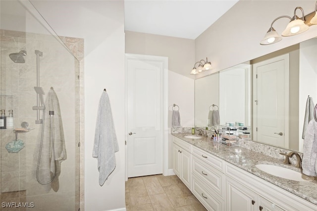 bathroom with a tile shower and vanity