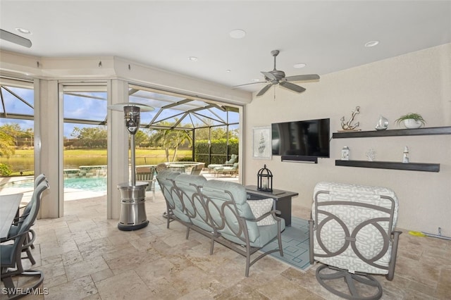 view of patio / terrace featuring outdoor lounge area, glass enclosure, and ceiling fan