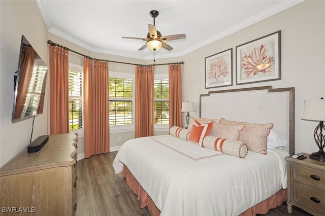 bedroom featuring dark hardwood / wood-style flooring, ceiling fan, and crown molding