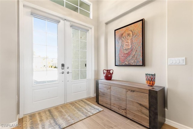 doorway to outside with light hardwood / wood-style floors and french doors