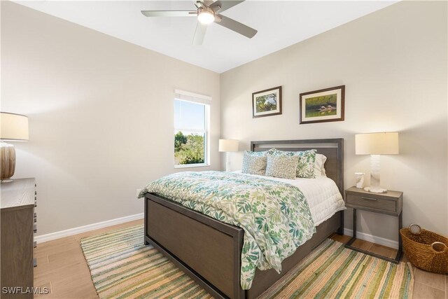 bedroom with ceiling fan and light hardwood / wood-style flooring