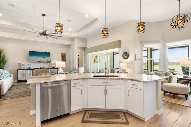 kitchen with white cabinetry, dishwasher, decorative light fixtures, and sink