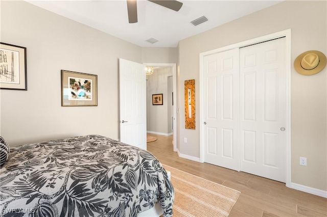 bedroom featuring ceiling fan, a closet, and light hardwood / wood-style floors