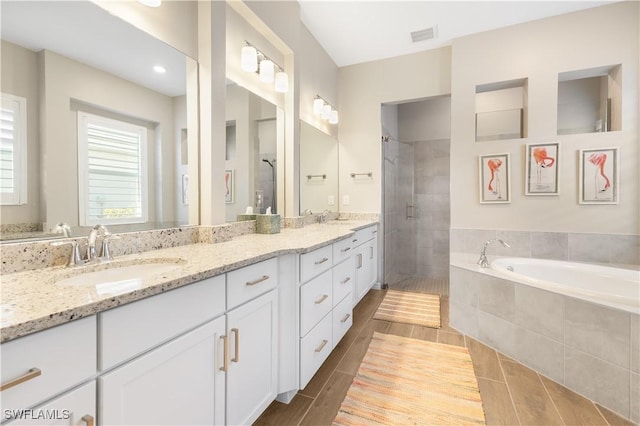 bathroom with tile patterned floors, vanity, and separate shower and tub