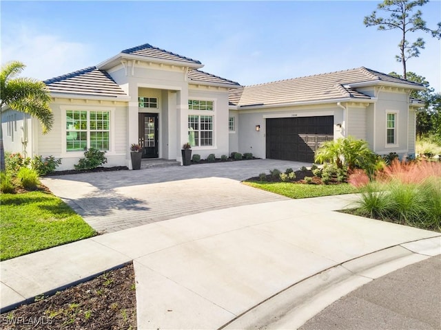 mediterranean / spanish-style house with a garage