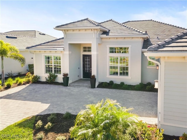 15844 Cranes Marsh Ct, Punta Gorda, FL 33982 - view of front of house featuring stucco siding and a tile roof