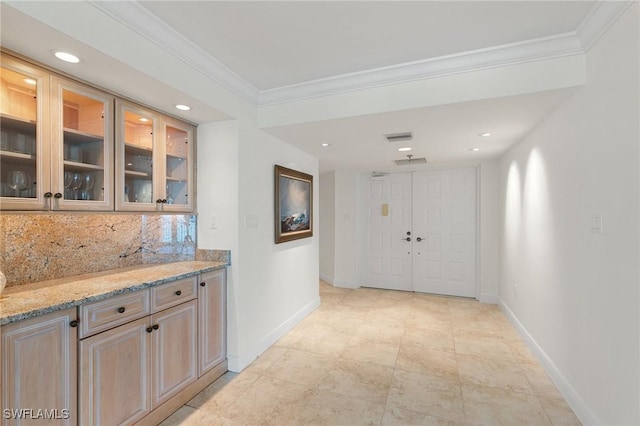 hall featuring crown molding and light tile patterned floors