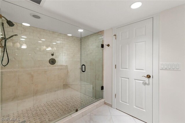 bathroom featuring a shower with door