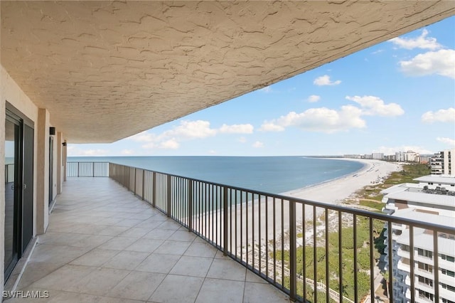 balcony with a view of the beach and a water view