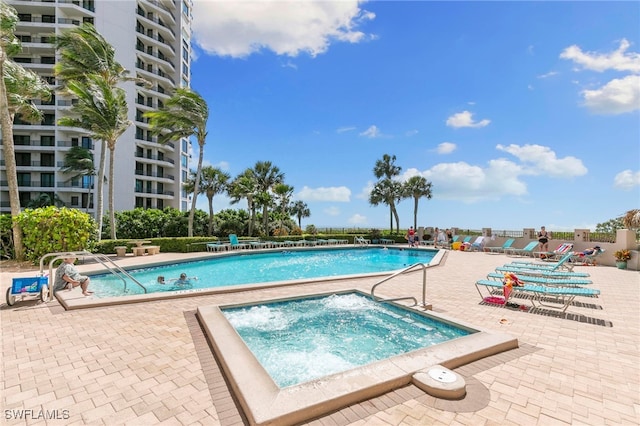 view of pool featuring a patio area and a community hot tub