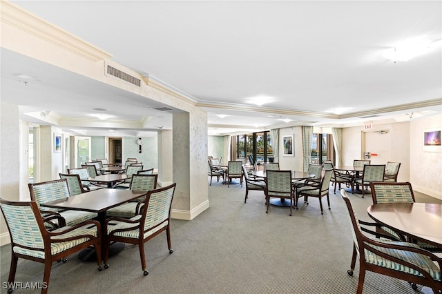 carpeted dining room with ornamental molding and a wealth of natural light