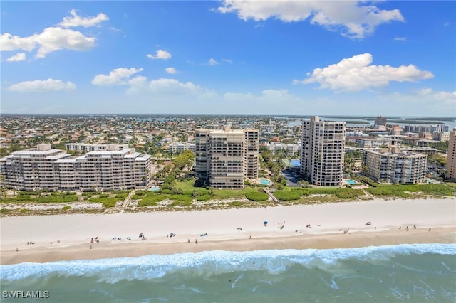 bird's eye view with a water view and a beach view