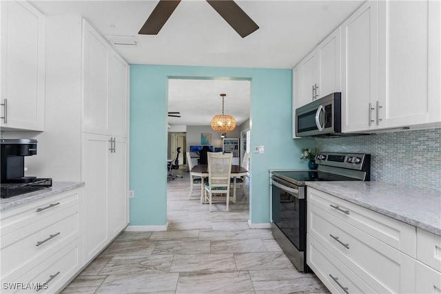 kitchen featuring tasteful backsplash, ceiling fan, white cabinets, and stainless steel appliances