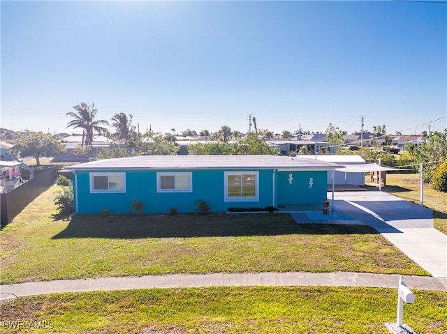 ranch-style house with a front lawn and a carport