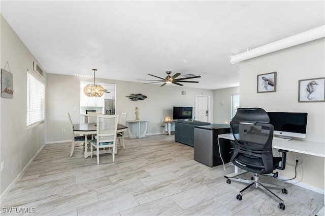 office space with ceiling fan with notable chandelier