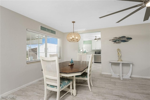 dining area with sink and a chandelier