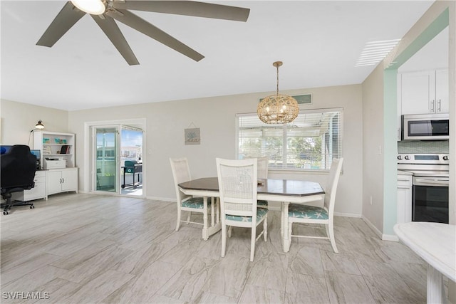 dining space with plenty of natural light and ceiling fan