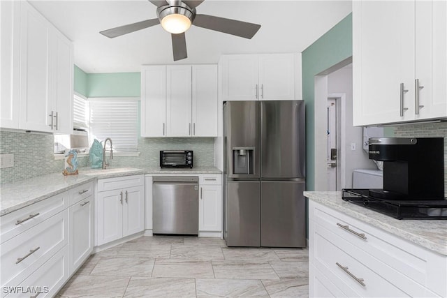 kitchen featuring white cabinets, stainless steel appliances, and sink