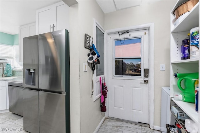 kitchen featuring white cabinetry, sink, and appliances with stainless steel finishes