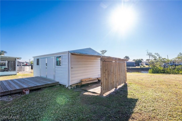 view of outbuilding with a yard