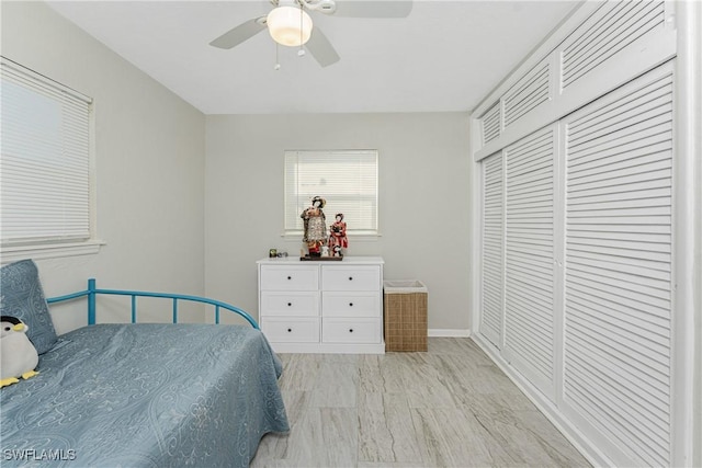 bedroom featuring light hardwood / wood-style floors, a closet, and ceiling fan