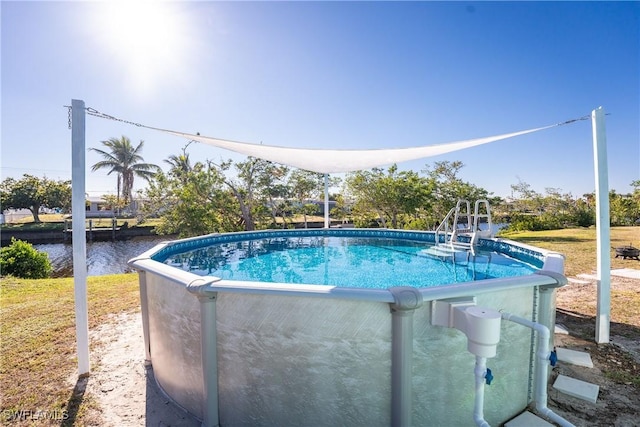 view of swimming pool featuring a water view