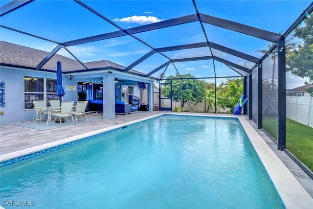 709 SW 9th Ct, Cape Coral, FL 33991 - view of swimming pool featuring an outdoor living space, ceiling fan, a patio, and a lanai