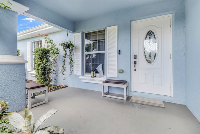 709 SW 9th Ct, Cape Coral, FL 33991 - property entrance with a porch and stucco siding