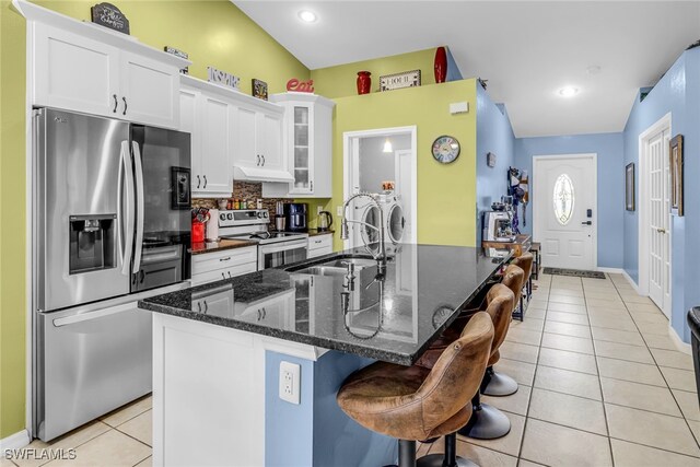 709 SW 9th Ct, Cape Coral, FL 33991 - kitchen featuring stainless steel appliances, a sink, light tile patterned floors, white cabinetry, and recessed lighting