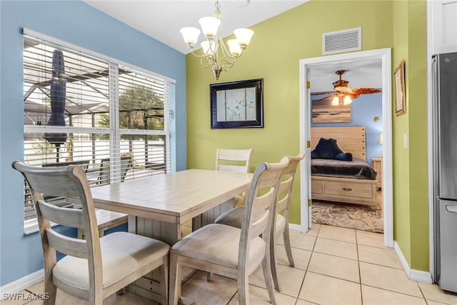 709 SW 9th Ct, Cape Coral, FL 33991 - dining area featuring a chandelier, baseboards, and light tile patterned floors