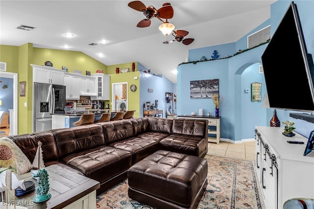 living room with ceiling fan, lofted ceiling, and light tile patterned floors