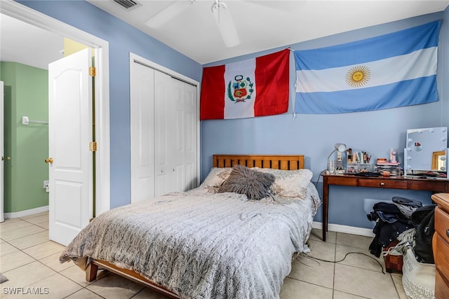 bedroom with tile patterned flooring, a closet, and ceiling fan