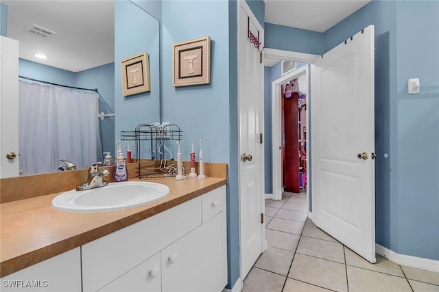 709 SW 9th Ct, Cape Coral, FL 33991 - bathroom featuring vanity, tile patterned floors, and baseboards
