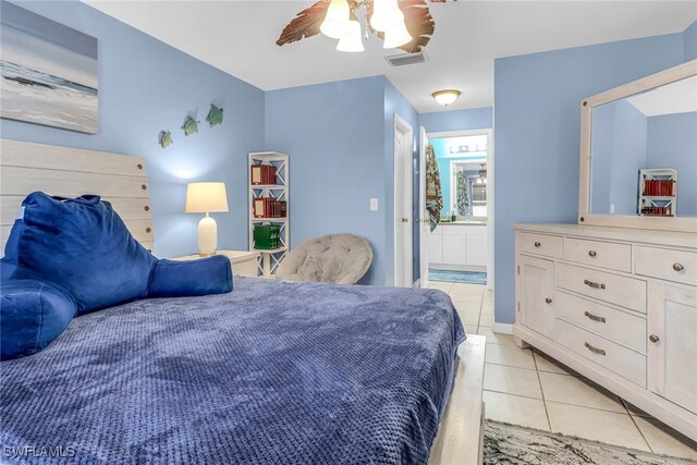 709 SW 9th Ct, Cape Coral, FL 33991 - bedroom with light tile patterned floors, ensuite bath, and ceiling fan