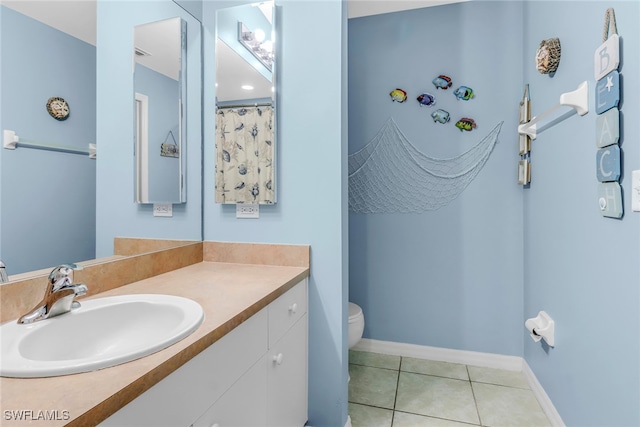 709 SW 9th Ct, Cape Coral, FL 33991 - full bath with vanity, toilet, tile patterned flooring, and baseboards
