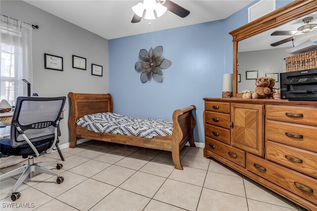 709 SW 9th Ct, Cape Coral, FL 33991 - bedroom with light tile patterned floors, a ceiling fan, and baseboards