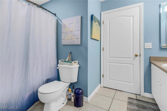 bathroom with toilet, vanity, tile patterned floors, and a shower with shower curtain