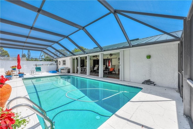 view of pool with a lanai, ceiling fan, and a patio area