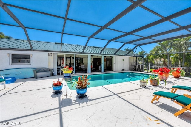 view of pool with a lanai, a patio area, and ceiling fan