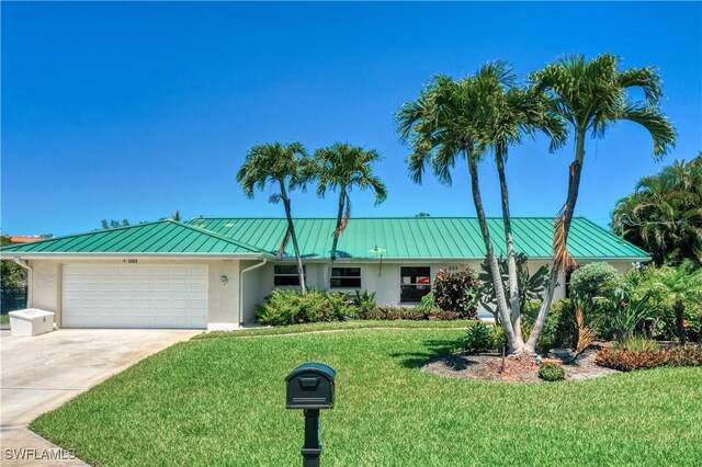 single story home with a garage and a front lawn