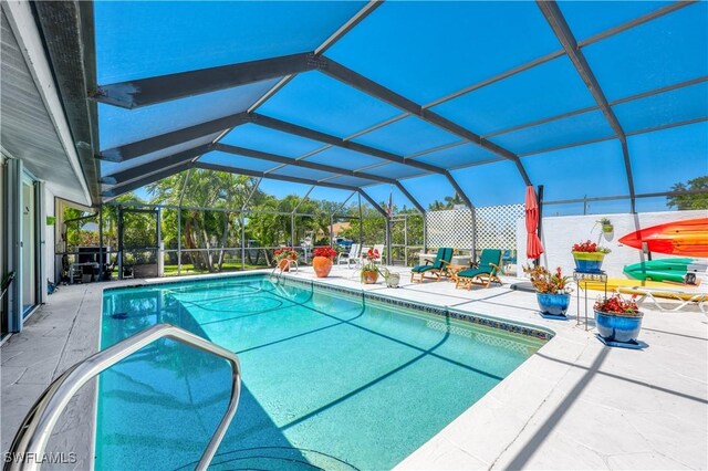 view of pool with a patio and a lanai