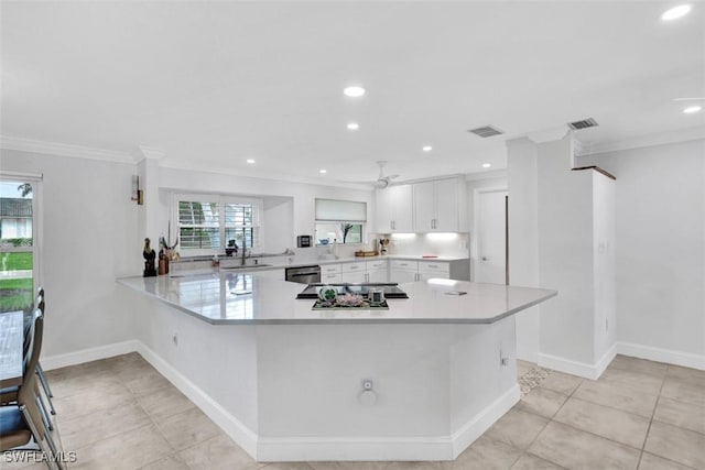 kitchen with white cabinetry, ceiling fan, stainless steel dishwasher, kitchen peninsula, and crown molding