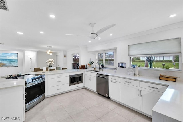 kitchen with white cabinetry, ornamental molding, and appliances with stainless steel finishes