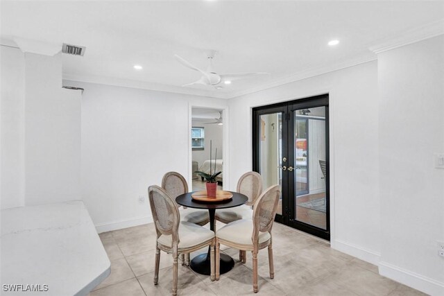 dining space featuring french doors, light tile patterned floors, ceiling fan, and crown molding