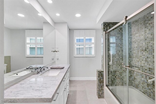 bathroom with tile patterned floors, plenty of natural light, vanity, and enclosed tub / shower combo