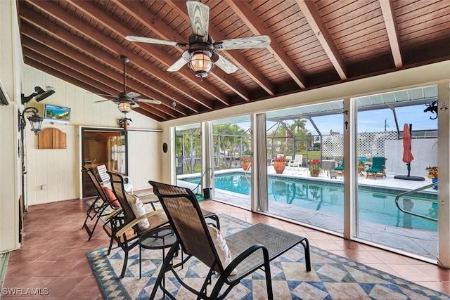 sunroom featuring vaulted ceiling with beams, a pool, wooden ceiling, and a wealth of natural light