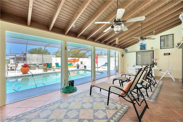 sunroom featuring vaulted ceiling with beams, ceiling fan, a swimming pool, and wood ceiling