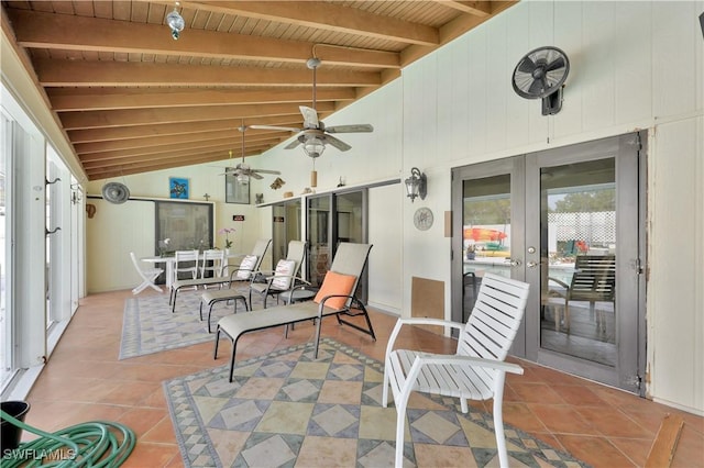 interior space featuring french doors, lofted ceiling with beams, ceiling fan, and wood ceiling