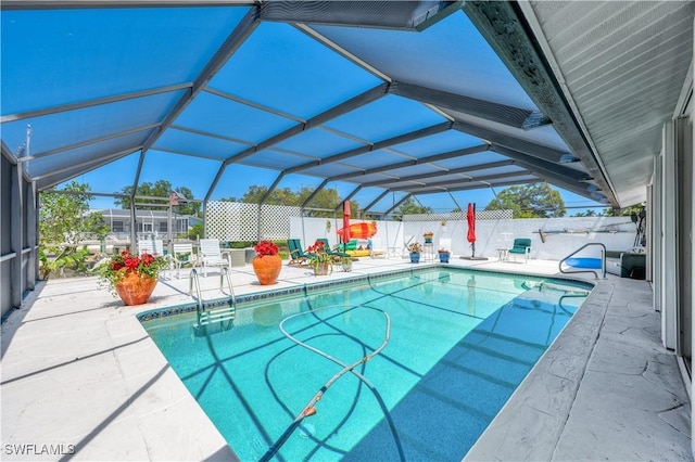 view of swimming pool with a lanai and a patio area